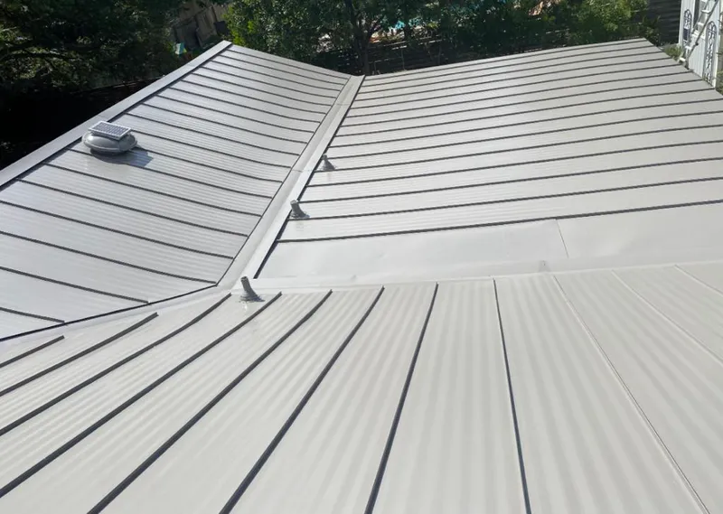 Solar attic fan installed on a metal roof for Roof Ventilation in Kinnelon